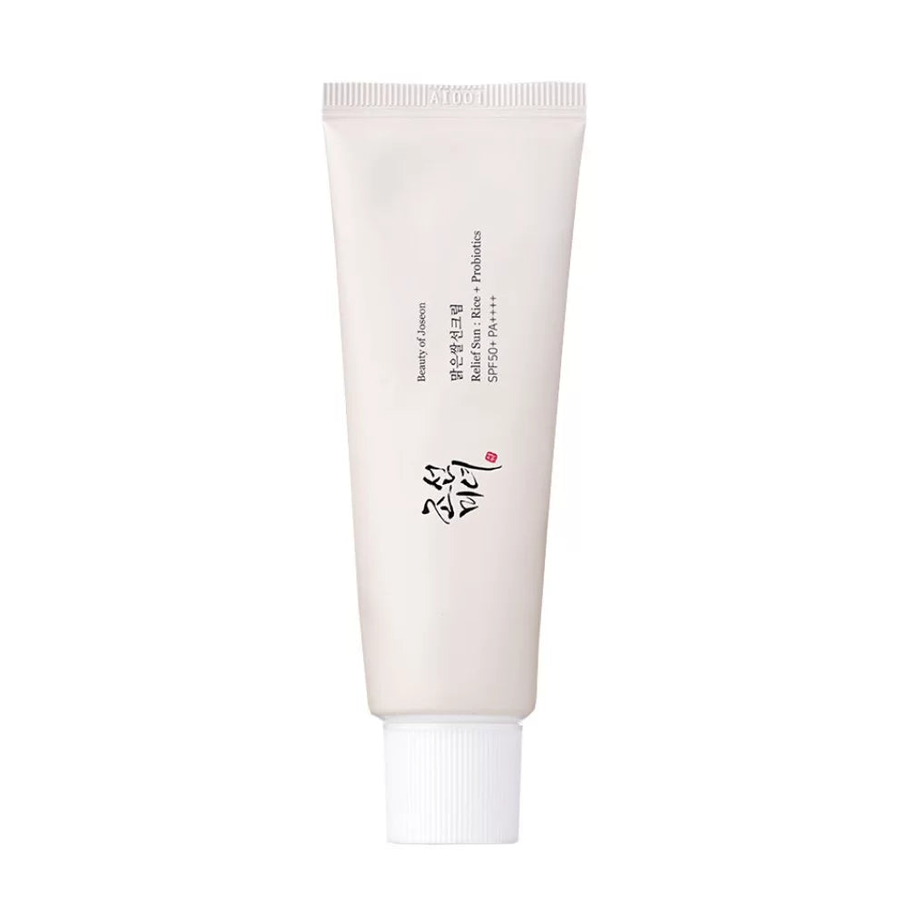 A tube of 'Beauty of Joseon Relief Sun' sunscreen with SPF50+ PA++++ protection, featuring rice and grain fermented extracts. The packaging is in a light beige tone with Korean text and a heart symbol.